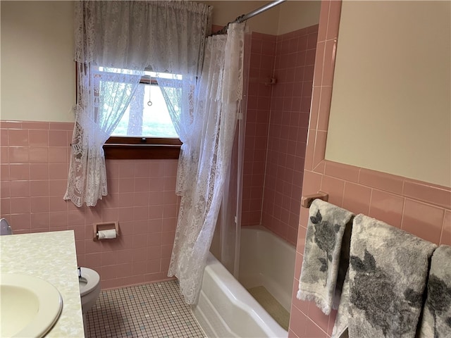 full bathroom with shower / bathtub combination with curtain, tile walls, toilet, and tile patterned flooring