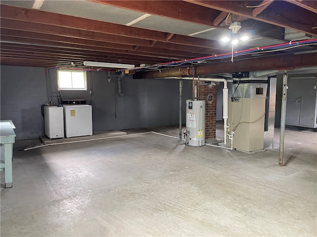 basement with washer and clothes dryer, heating unit, and water heater