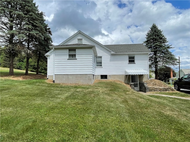 rear view of property featuring a lawn