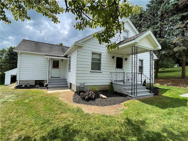 rear view of property with a yard