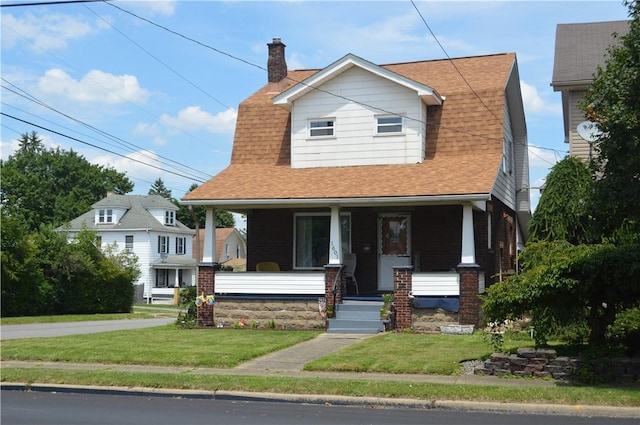 view of front of property with a porch and a front lawn