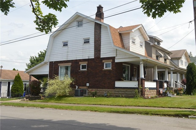 view of property exterior with covered porch, central AC, and a lawn