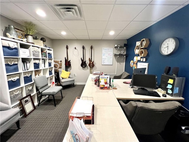 carpeted office space with a paneled ceiling