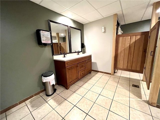 bathroom with vanity, a paneled ceiling, and tile patterned floors