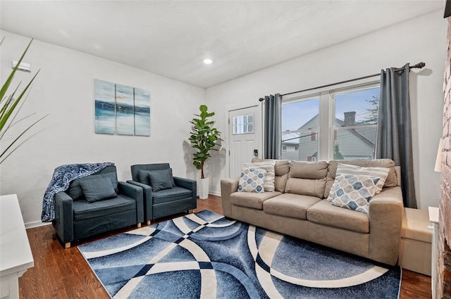 living room featuring recessed lighting, dark wood-type flooring, and baseboards