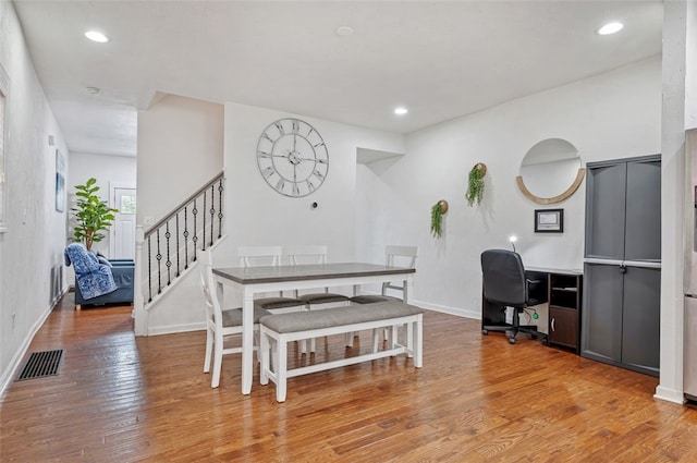 dining area featuring visible vents, recessed lighting, stairway, wood-type flooring, and baseboards