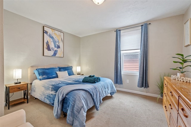 carpeted bedroom with baseboards