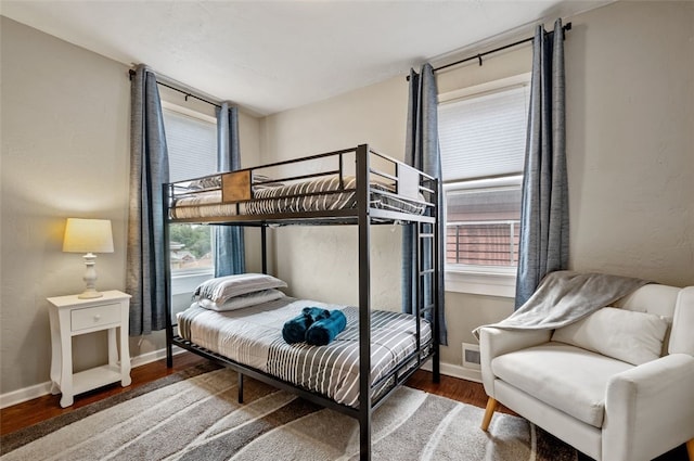 bedroom with baseboards and wood finished floors