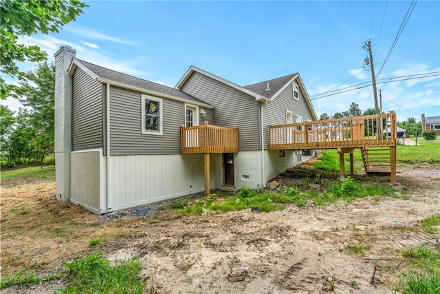 back of property with a wooden deck