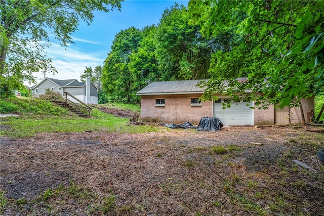 rear view of property with a garage