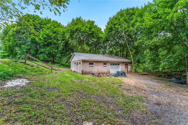 58 Wansack Rd, Shenango Twp Mer, PA 16159 - garage featuring dirt driveway and a view of trees