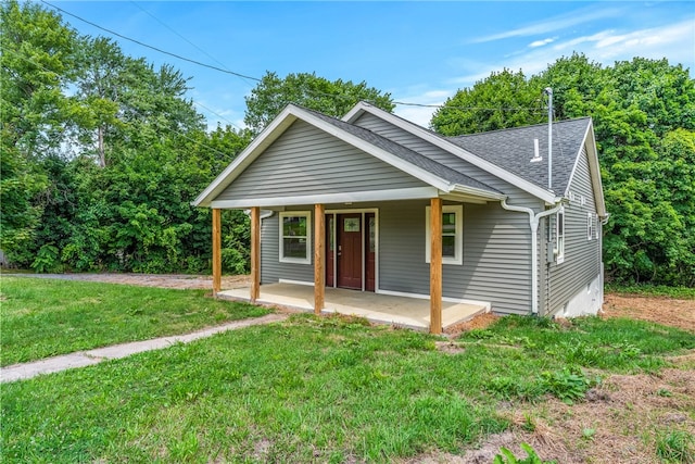 bungalow-style home with a front yard