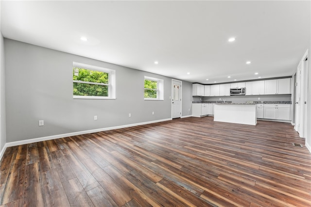 unfurnished living room featuring dark hardwood / wood-style flooring