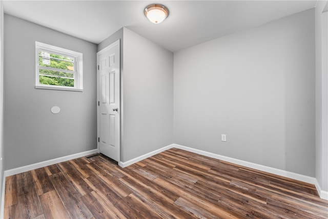 empty room with dark hardwood / wood-style floors