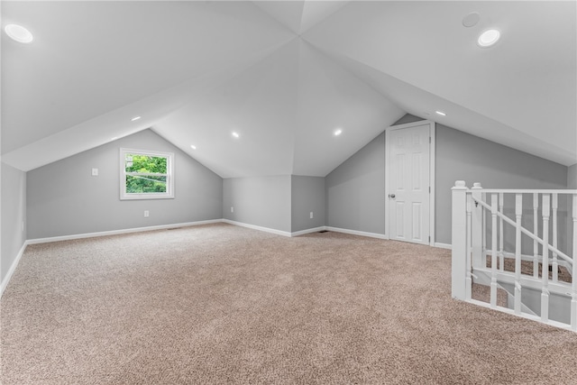 additional living space with lofted ceiling and carpet flooring