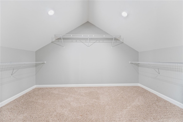 spacious closet with carpet floors and lofted ceiling