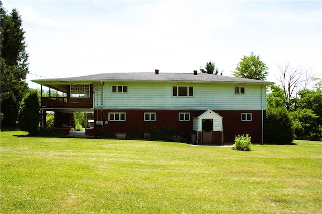 back of property featuring a yard