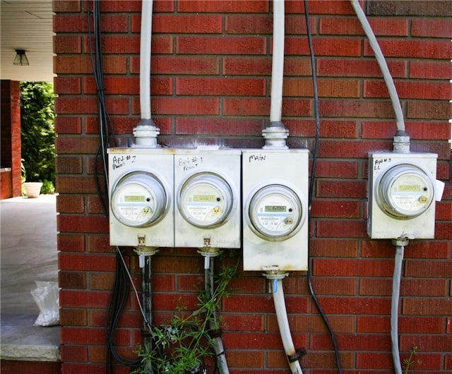 details featuring brick siding and electric meter