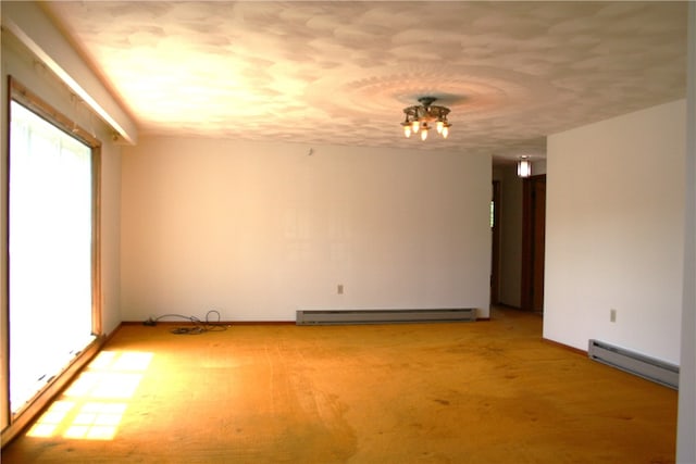 unfurnished room featuring baseboard heating