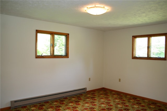 unfurnished room featuring baseboards, baseboard heating, and a textured ceiling