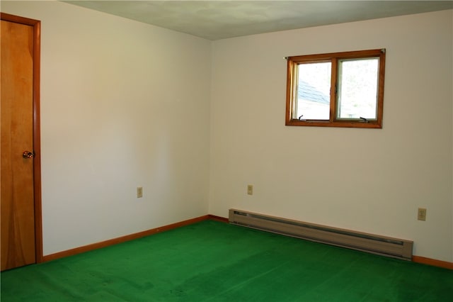 carpeted spare room featuring baseboard heating