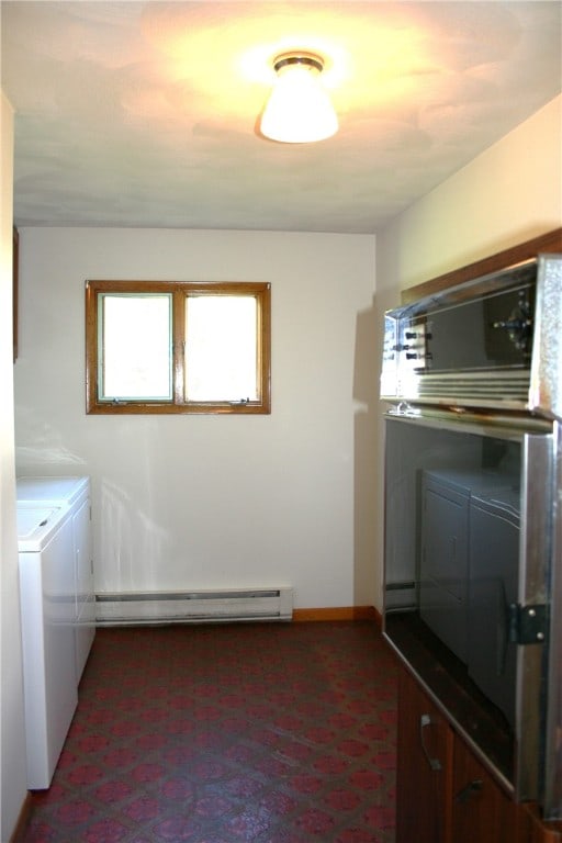 washroom with washing machine and clothes dryer and a baseboard radiator