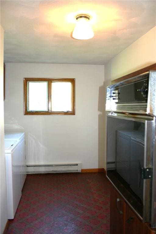 laundry area featuring a baseboard radiator, baseboards, washing machine and dryer, and laundry area