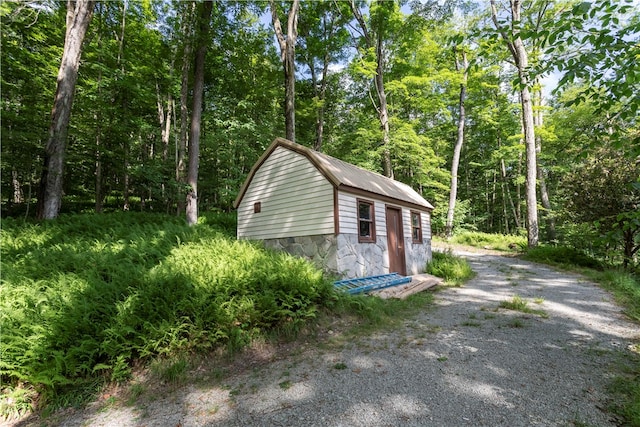 view of property exterior featuring an outbuilding