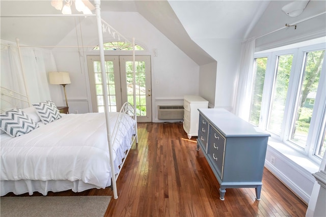 bedroom with dark hardwood / wood-style floors, lofted ceiling, and multiple windows