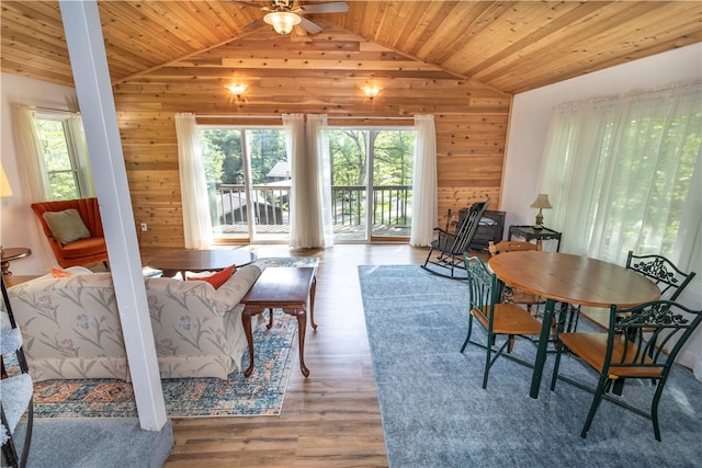 dining room featuring a wealth of natural light, hardwood / wood-style flooring, vaulted ceiling, and wood ceiling