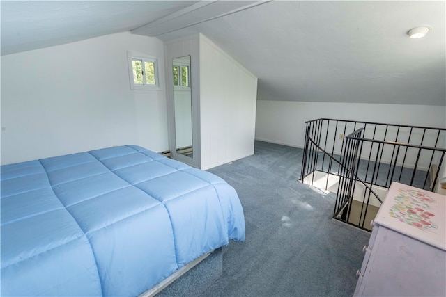 bedroom featuring dark carpet and vaulted ceiling