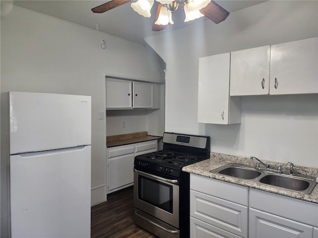 kitchen featuring gas range, white refrigerator, ceiling fan, sink, and dark wood-type flooring