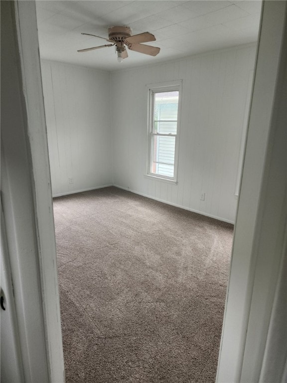 spare room with carpet floors and ceiling fan