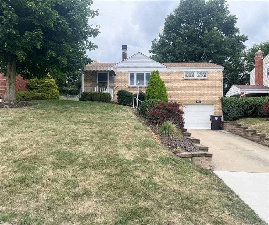 view of front of house featuring a garage and a front lawn