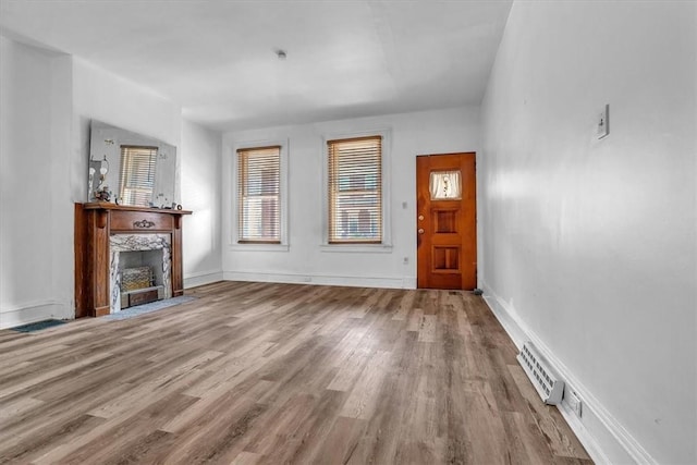 unfurnished living room featuring light wood-type flooring