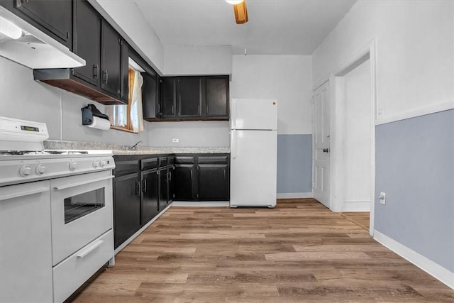 kitchen with white appliances, sink, and light hardwood / wood-style floors