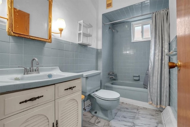 full bathroom featuring shower / bath combination with curtain, vanity, toilet, and tile walls