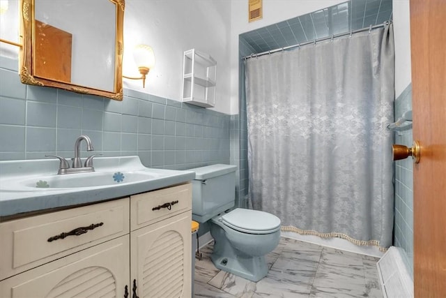 bathroom featuring walk in shower, vanity, toilet, and tile walls