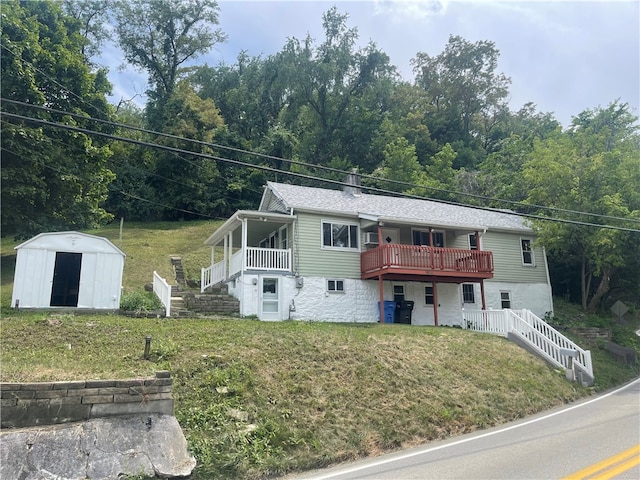 view of front facade with a front lawn and a shed