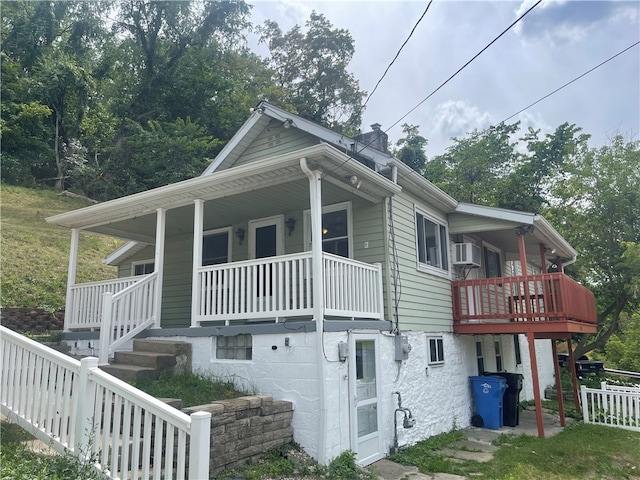 view of side of home with covered porch