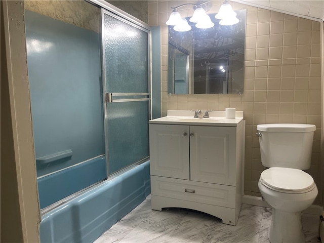 full bathroom featuring tile walls, shower / bath combination with glass door, tile patterned floors, toilet, and vanity