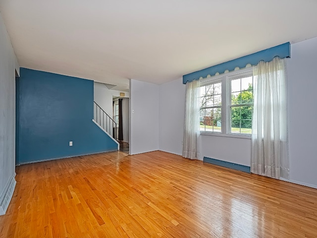 empty room featuring light hardwood / wood-style flooring and a baseboard radiator