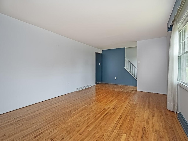 empty room with light hardwood / wood-style floors