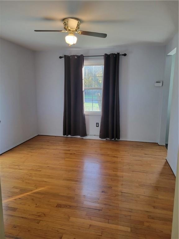 spare room with light hardwood / wood-style flooring and ceiling fan