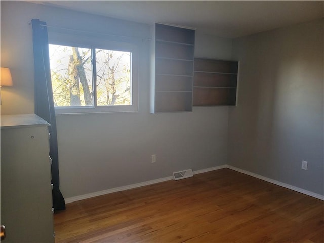 unfurnished room featuring dark hardwood / wood-style flooring