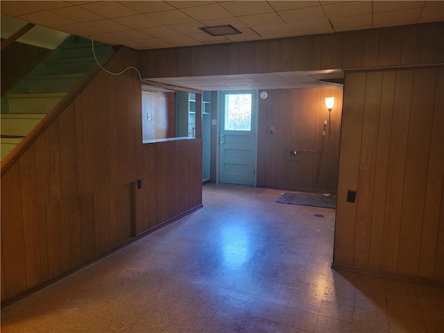 basement featuring wooden walls