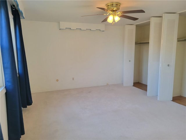 unfurnished bedroom featuring ceiling fan and light carpet