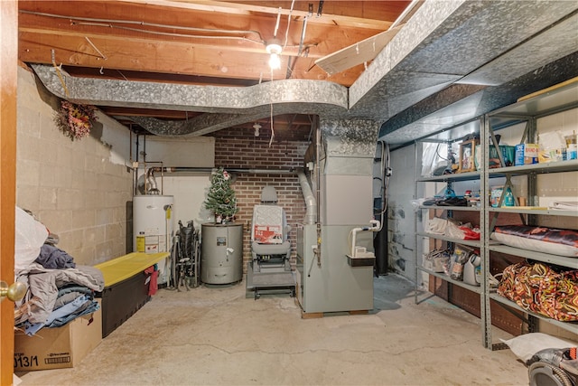 basement featuring heating unit, brick wall, and water heater