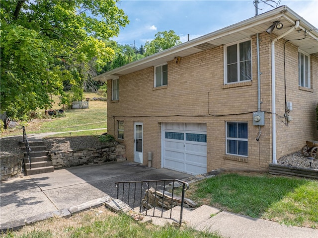 view of side of home with a garage and a patio area