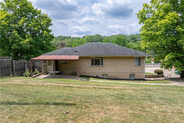 back of property with a patio and a lawn